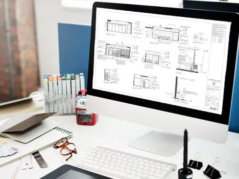 Bản vẽ kiến trúc hiển thị trên màn hình máy tính, không gian làm việc gọn gàng.