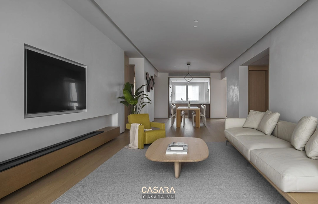 phòng khách nhà phố hẹp ngang với sofa văng và kệ tivi gọn
