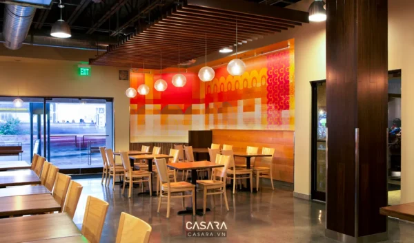 Không gian nhà hàng hiện đại với bức tranh tường nghệ thuật nổi bật.