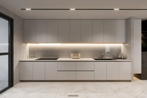 Phòng bếp hiện đại, tối giản với tủ bếp trắng và ánh sáng dịu nhẹ.