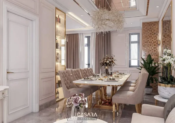 Không gian phòng ăn sang trọng với nội thất màu trắng và vàng.