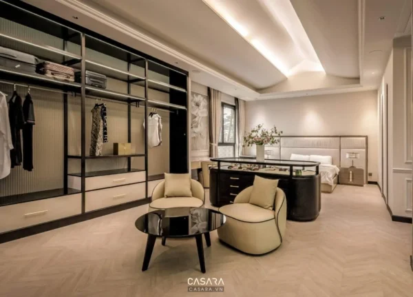 Phòng ngủ hiện đại, sang trọng với tủ quần áo lớn và khu vực tiếp khách ấm cúng.