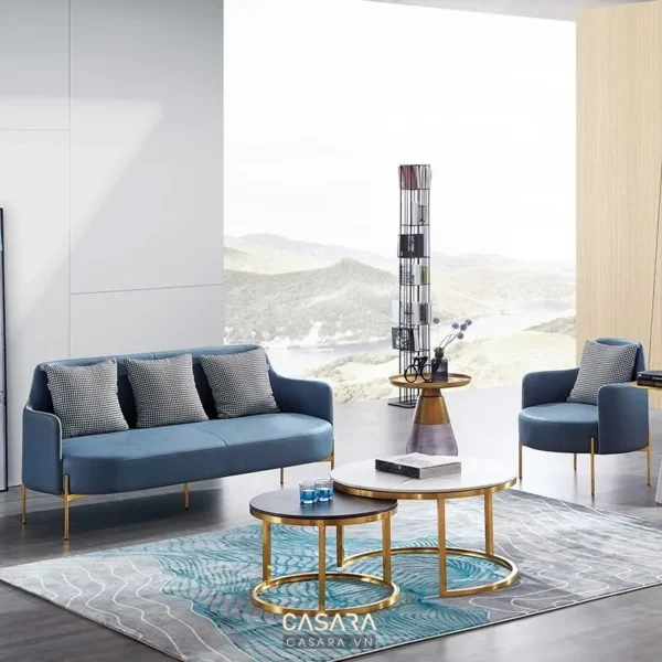 Phòng khách hiện đại với sofa xanh navy và bàn trà vàng kim.