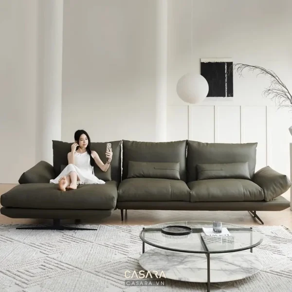 Phòng khách hiện đại, sang trọng với sofa màu xám và cô gái trẻ thư giãn.