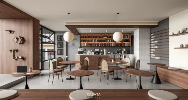 Không gian quán cafe nhỏ có bàn tròn, ghế gỗ và quầy bar ấm