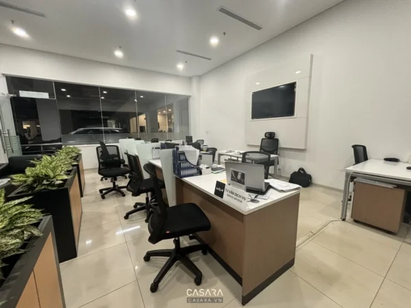 Văn phòng làm việc hiện đại, ngăn nắp với nhiều bàn ghế và ánh sáng.