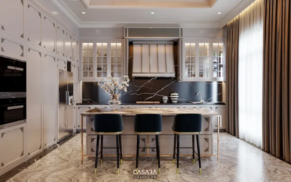 Phòng bếp hiện đại, sang trọng với tủ bếp trắng và đảo bếp gỗ.