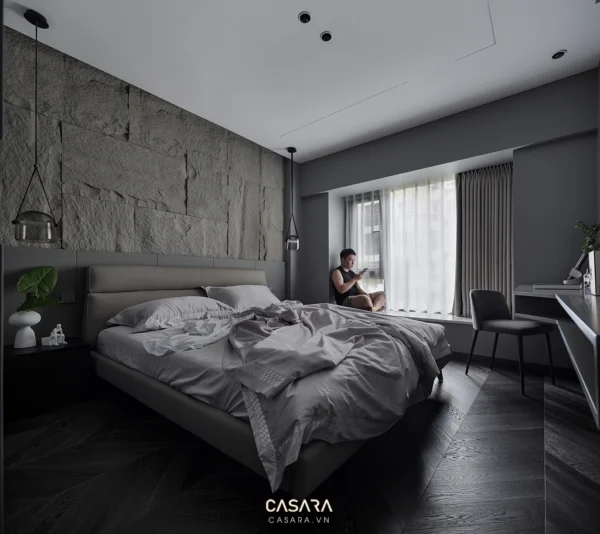 Phòng ngủ hiện đại tối giản với tường đá và ánh sáng dịu nhẹ.