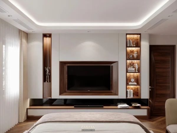 Phòng ngủ hiện đại, tối giản với TV lớn và tủ gỗ trang trí.