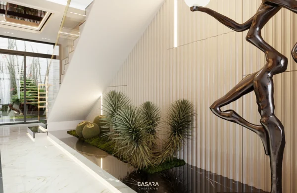 Nội thất hiện đại với tiểu cảnh xanh và tượng nghệ thuật độc đáo.