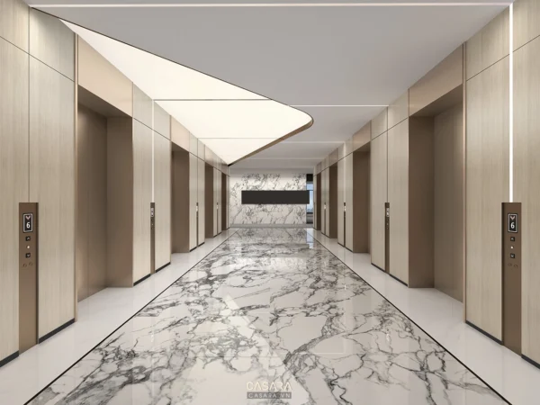 Hành lang thang máy sang trọng với sàn đá cẩm thạch và ánh sáng ấm áp.