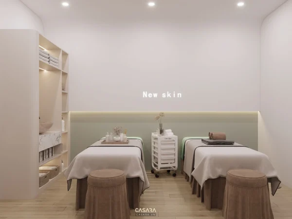 Phòng spa sáng sủa, thiết kế tối giản với hai giường massage song song.