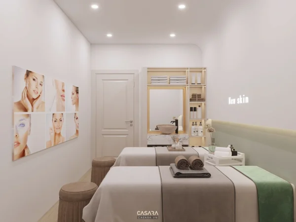 Phòng spa sáng sủa, thiết kế tối giản với giường massage và tranh tường.