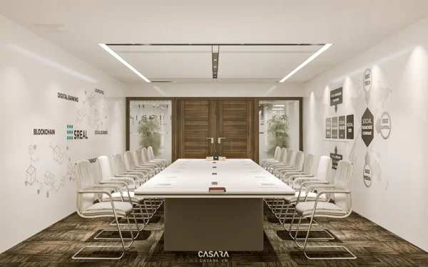 Phòng họp hiện đại với bàn dài, ghế trắng và tường trang trí.