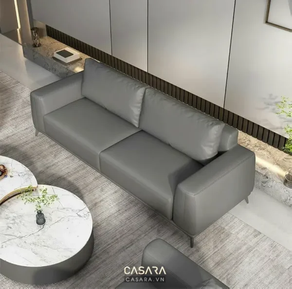 Góc phòng khách hiện đại với ghế sofa màu xám và bàn tròn đá cẩm thạch.