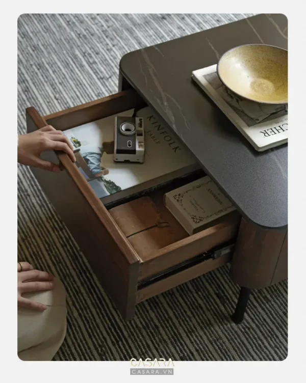 Bàn trà gỗ mở ngăn kéo, chứa đồ dùng cá nhân và sách báo.