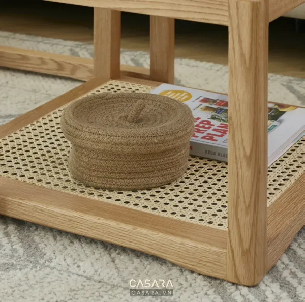 Bàn trà gỗ kết hợp mây tre đan, trang trí cùng sách và hộp đựng đồ thủ công.