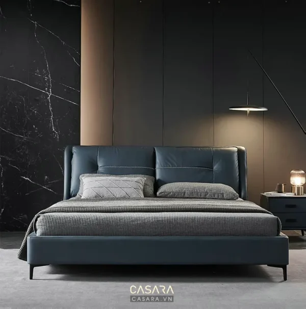 Phòng ngủ sang trọng với giường bọc da xanh navy hiện đại.