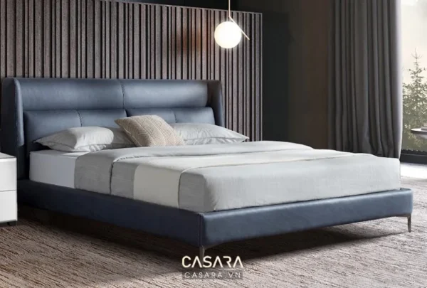 Giường ngủ hiện đại, sang trọng với tông màu xanh navy chủ đạo.