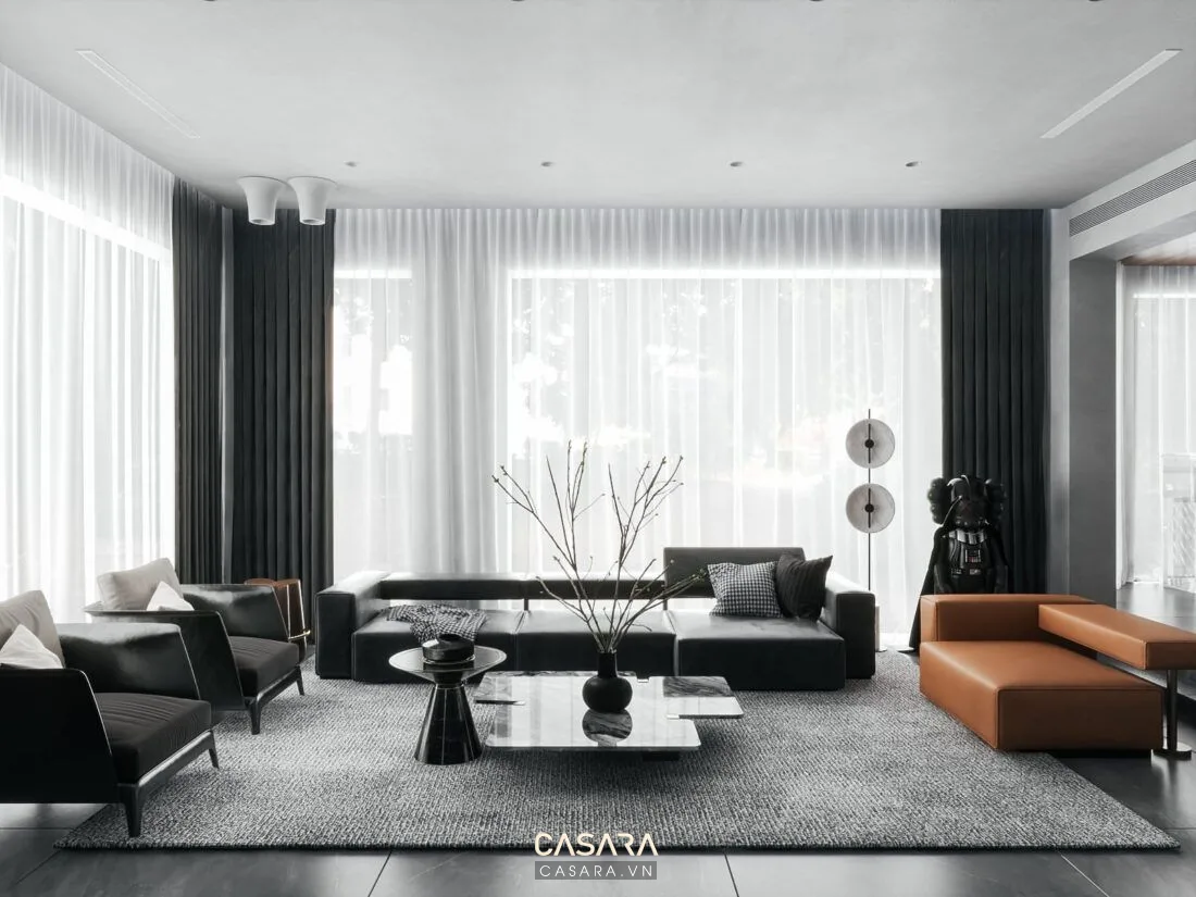 công ty thiết kế nội thất biệt thự bố trí phòng khách lớn với sofa vách gỗ đèn trang trí và cầu thang