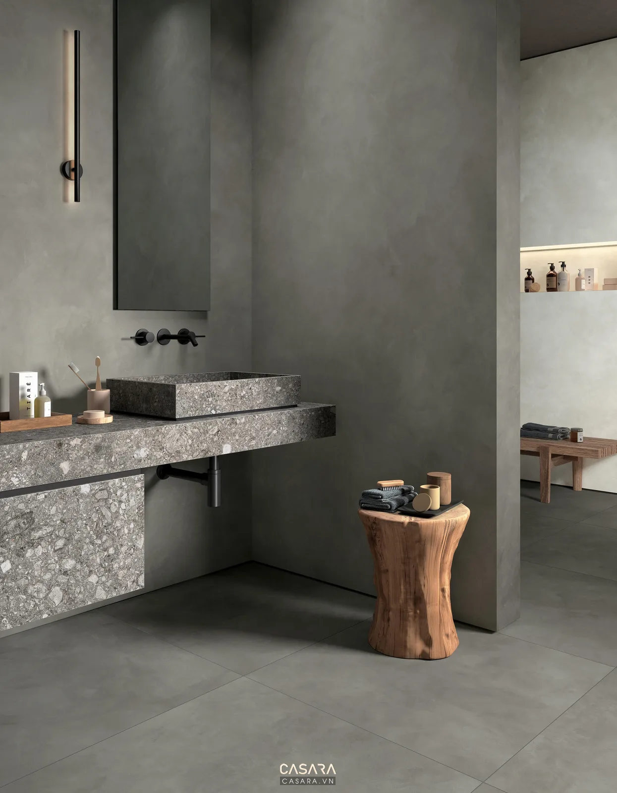 Lavabo đá xám với vòi âm tường và cây trang trí