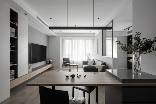 Phòng khách hiện đại với sofa, bàn trà, vách tivi, tủ kệ và ánh sáng tự nhiên