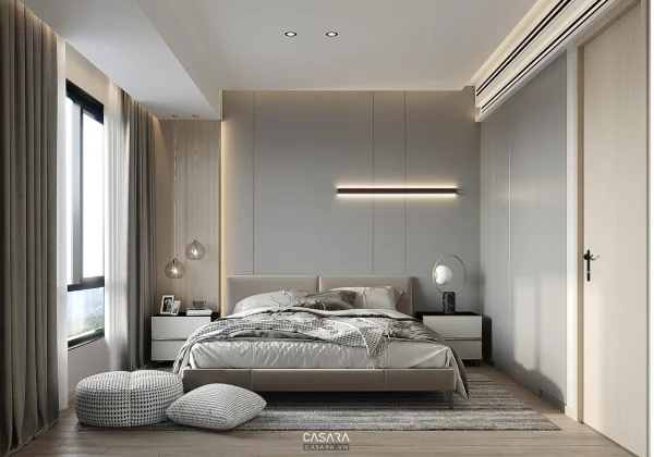 Phòng ngủ tone xám hiện đại với giường thấp, đèn thả ngang và ánh sáng ấm