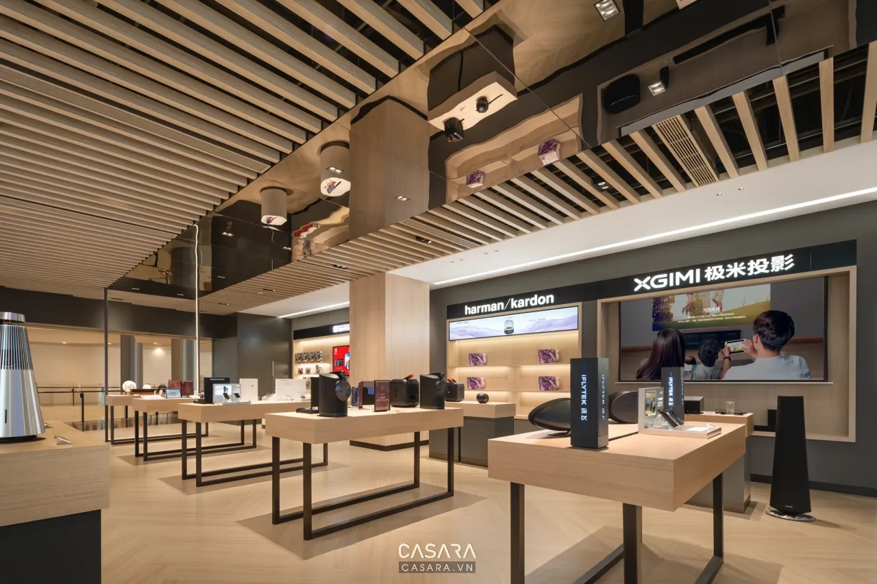 Showroom điện máy có quầy trải nghiệm và trần lam gỗ, minh họa ánh sáng cho sản phẩm trưng bày.