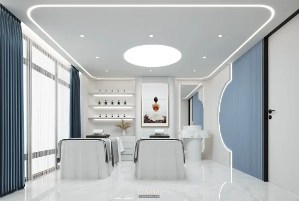 Phòng spa trắng xanh có giường trị liệu kệ mỹ phẩm và ánh sáng trần