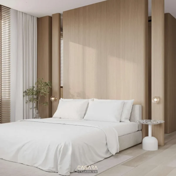 Phòng ngủ master có phòng thay đồ mở, giường sáng màu và vách đầu giường nhẹ
