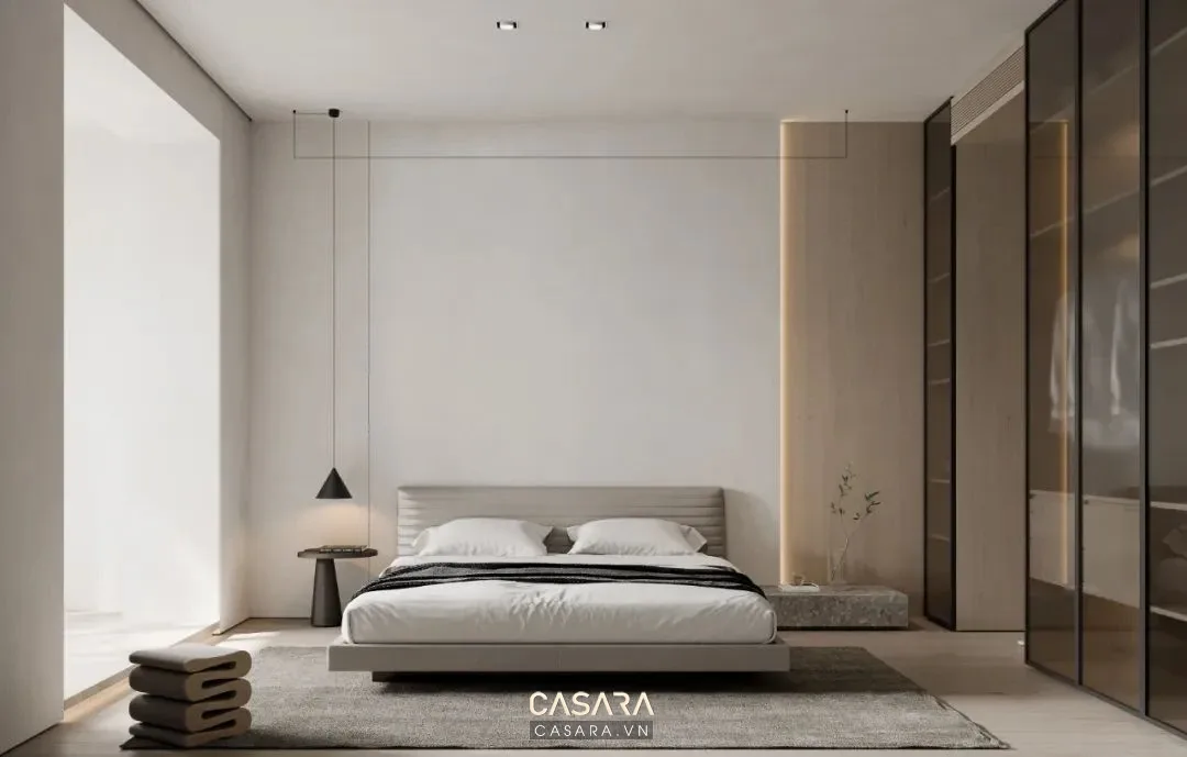 Phòng ngủ tối giản có bàn làm việc, vách tivi thấp, ánh sáng ấm và tủ gọn. nhà phong cách hiện đại tối giản nội thất gọn ánh sáng ấm lưu trữ kín Casara https://casara.vn/