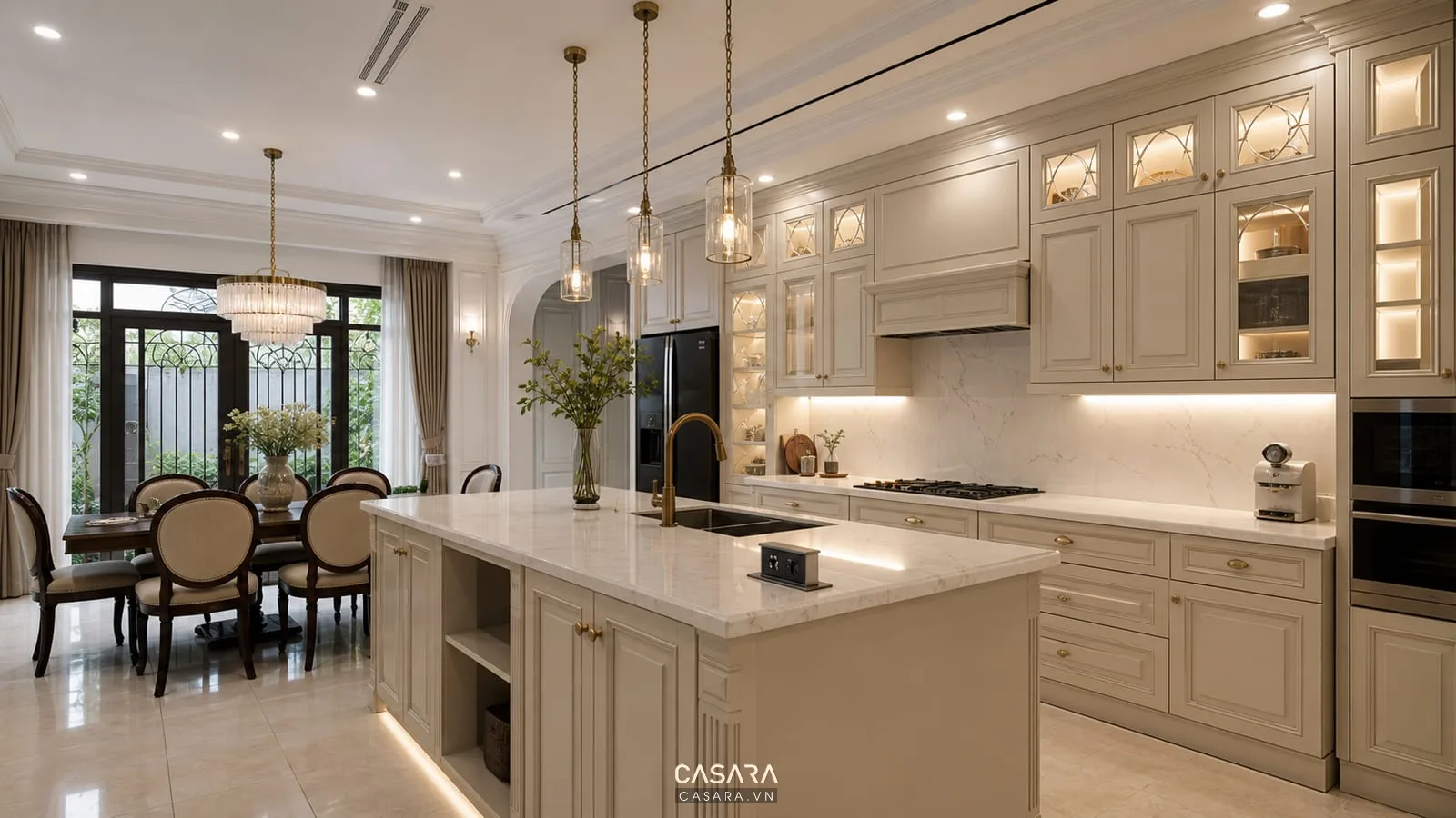 Tủ bếp biệt thự tân cổ điển có đảo bếp đèn thả và hệ lưu trữ tiện dụng