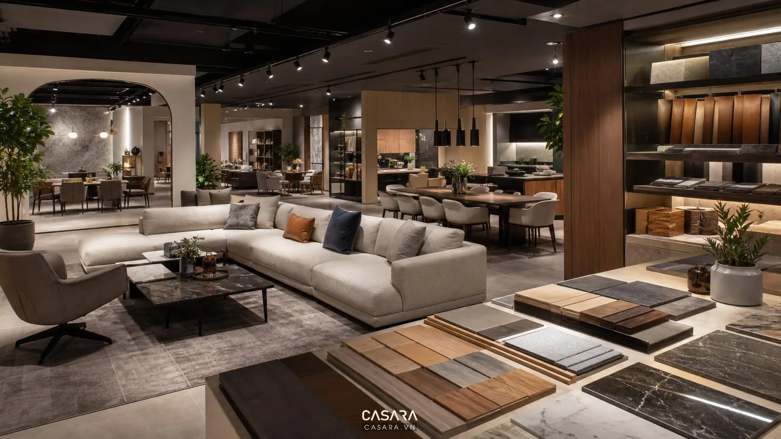 Thiết kế showroom đèn với đèn ray chiếu điểm, sofa, bàn ăn, kệ trưng bày và khu tư vấn vật liệu.