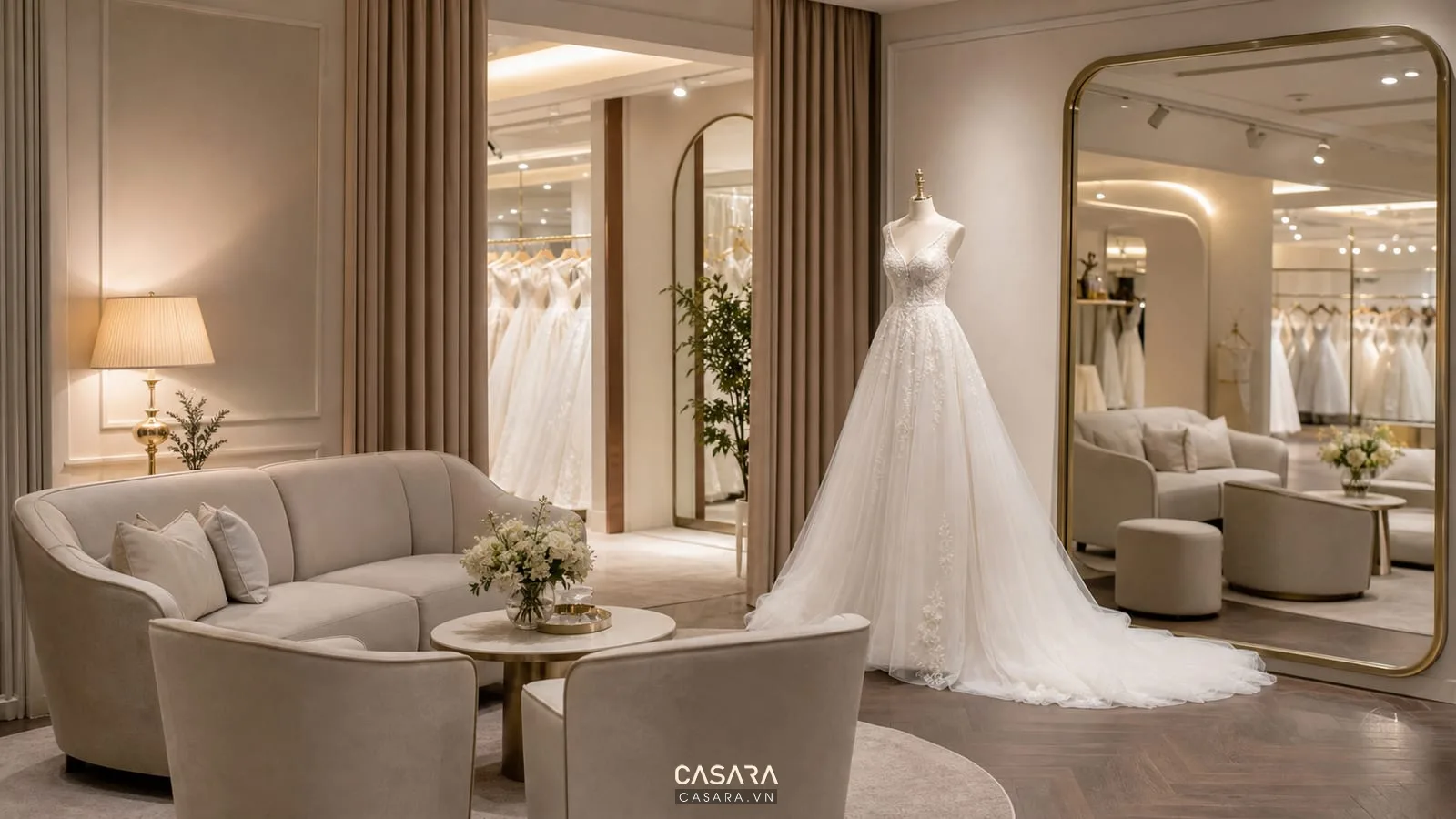 khu tư vấn showroom váy cưới với sofa sáng màu và váy cưới trắng
