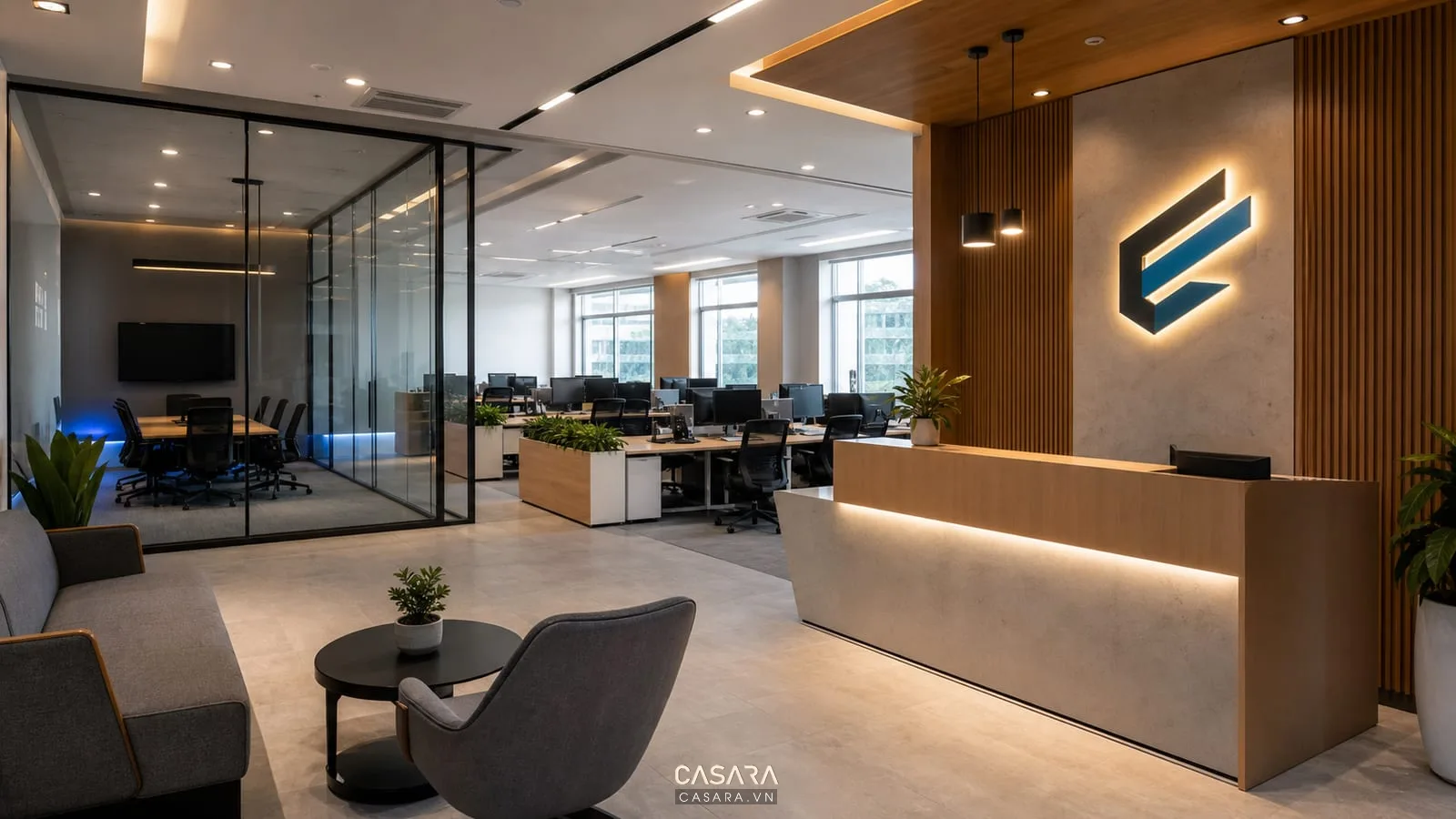 Khu tiếp khách văn phòng IT có logo công ty và phòng họp kính