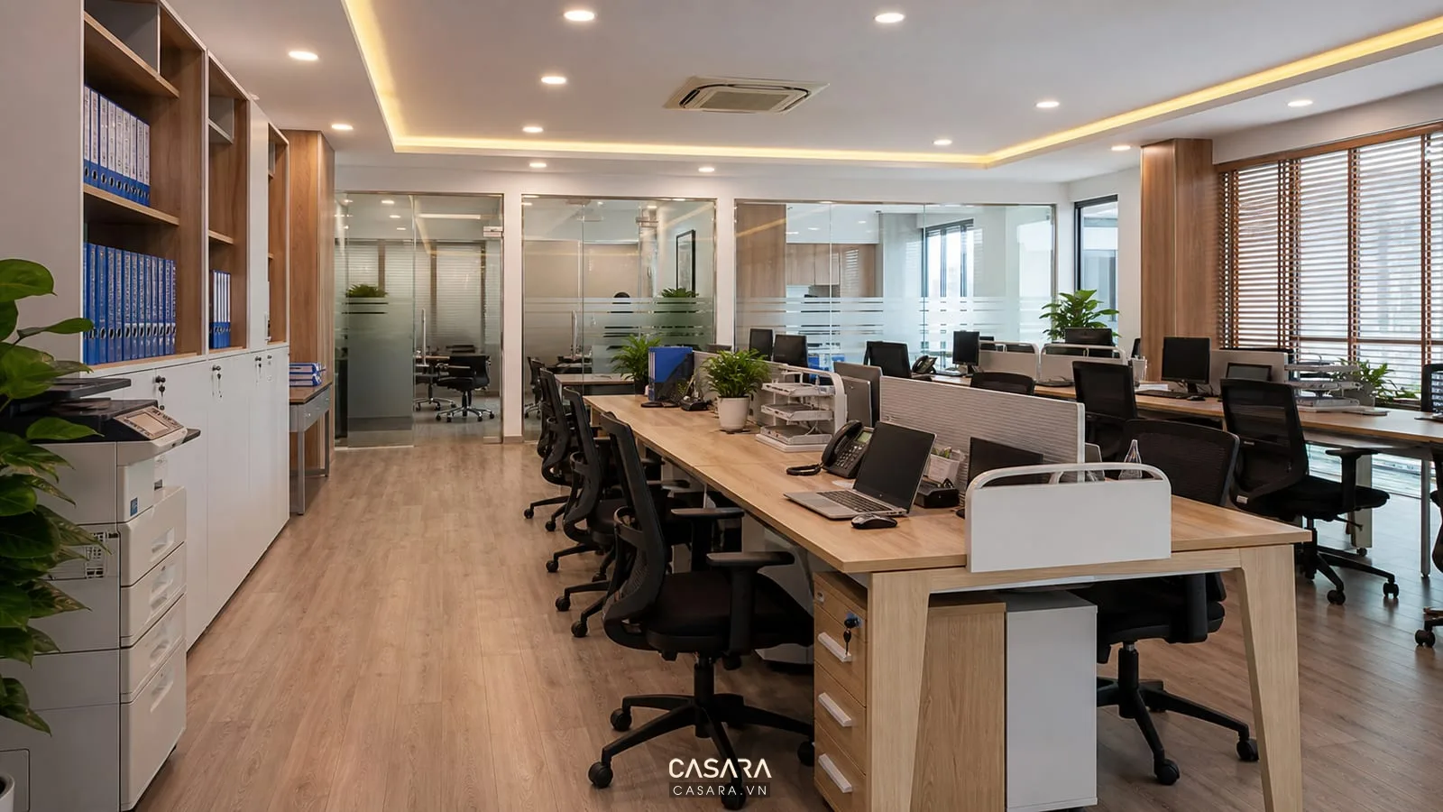 Khu làm việc nhân sự văn phòng tư vấn du học với bàn cụm máy in và tủ hồ sơ
