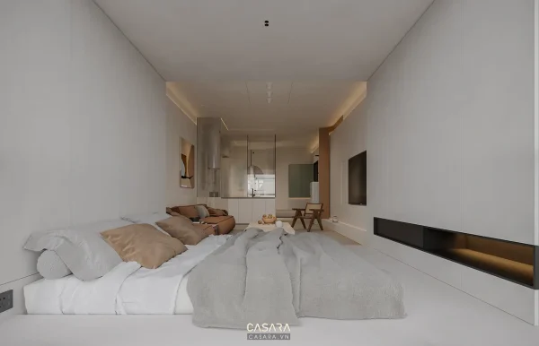 Phòng ngủ hiện đại tông trắng với giường thấp, sofa nhỏ và hốc tường trang trí