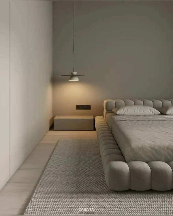 Phòng ngủ hiện đại với giường bọc nệm, tủ âm tường và đèn thả đầu giường