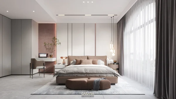 Ảnh phòng ngủ rộng có giường lớn, tủ áo xám liền tường, bàn trang điểm cạnh cửa sổ, ghế đôn cuối giường và rèm cao.