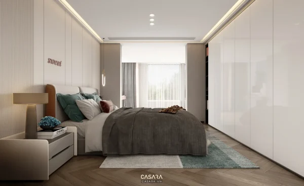 Phòng ngủ hiện đại có giường bọc nệm, tủ quần áo trắng âm tường và ánh sáng trần hắt nhẹ