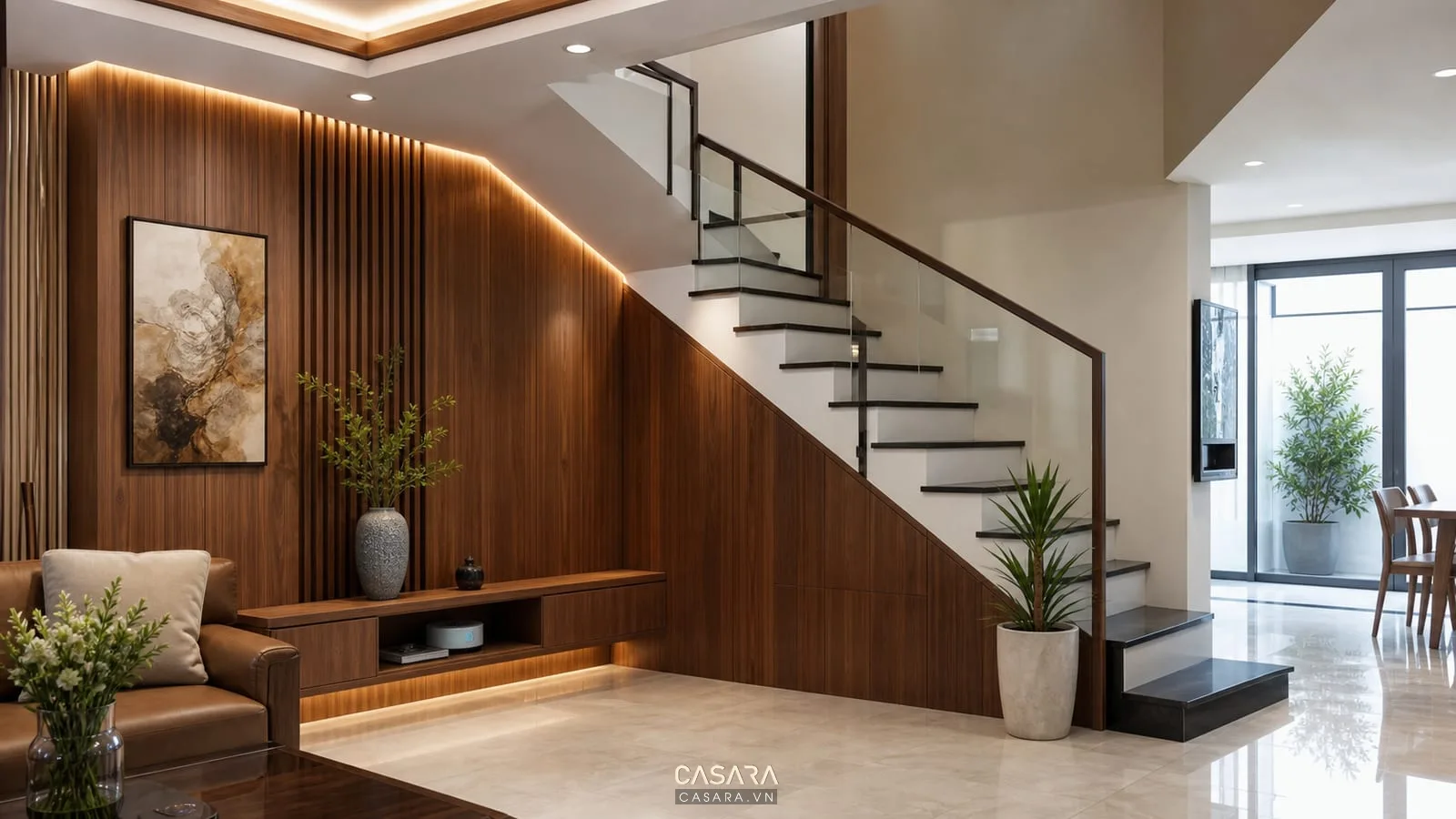 Trang trí góc cầu thang đẹp với tường ốp gỗ đèn hắt và tranh trong nhà phố