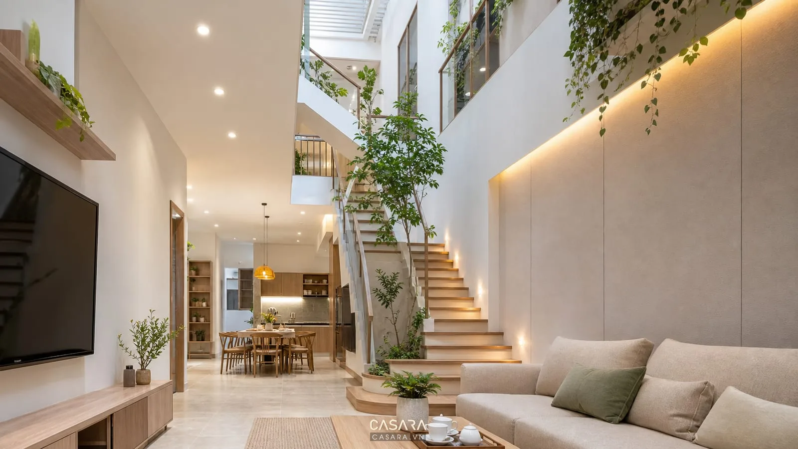 Cầu thang dọc nhà ống 3 tầng có giếng trời cây xanh và đèn hắt