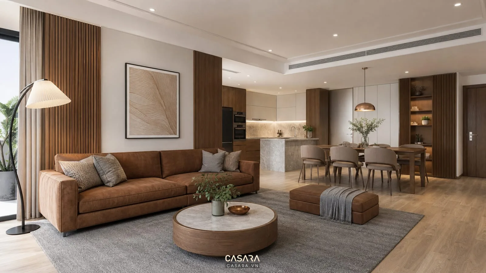 Phòng khách không gian mở với sofa nâu, vách gỗ và bàn ăn liên thông