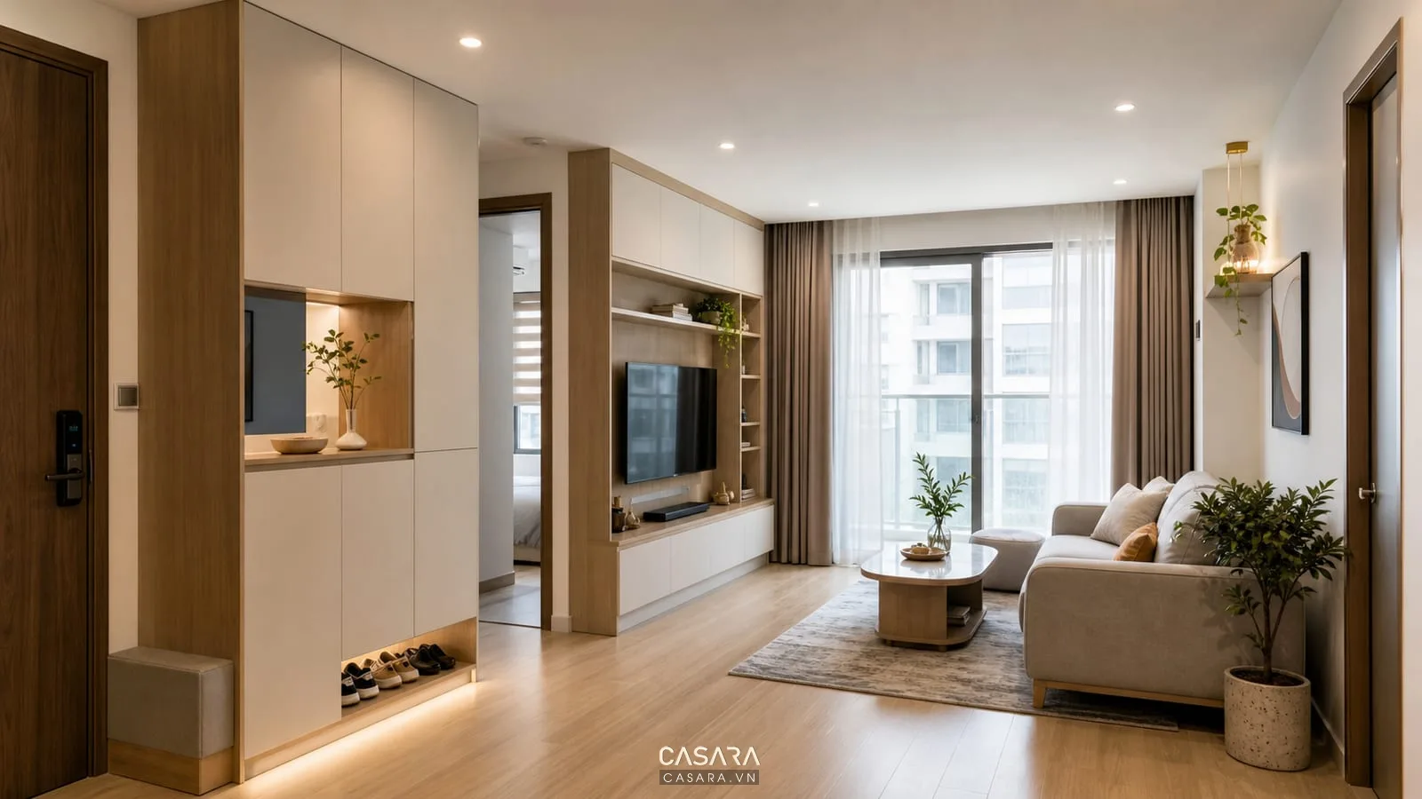 phòng khách căn hộ có kệ tivi tủ lưu trữ và tủ giày gần lối vào