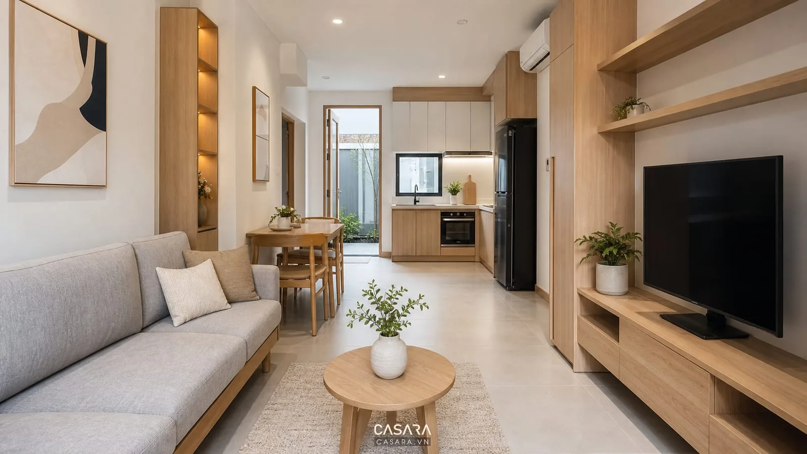 Phòng khách bếp nhà 50m2 một phòng ngủ có sofa gọn bàn ăn nhỏ và tủ bếp sáng màu