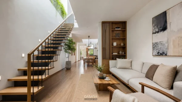 Thiết kế nhà ống cầu thang dọc cạnh phòng khách hiện đại