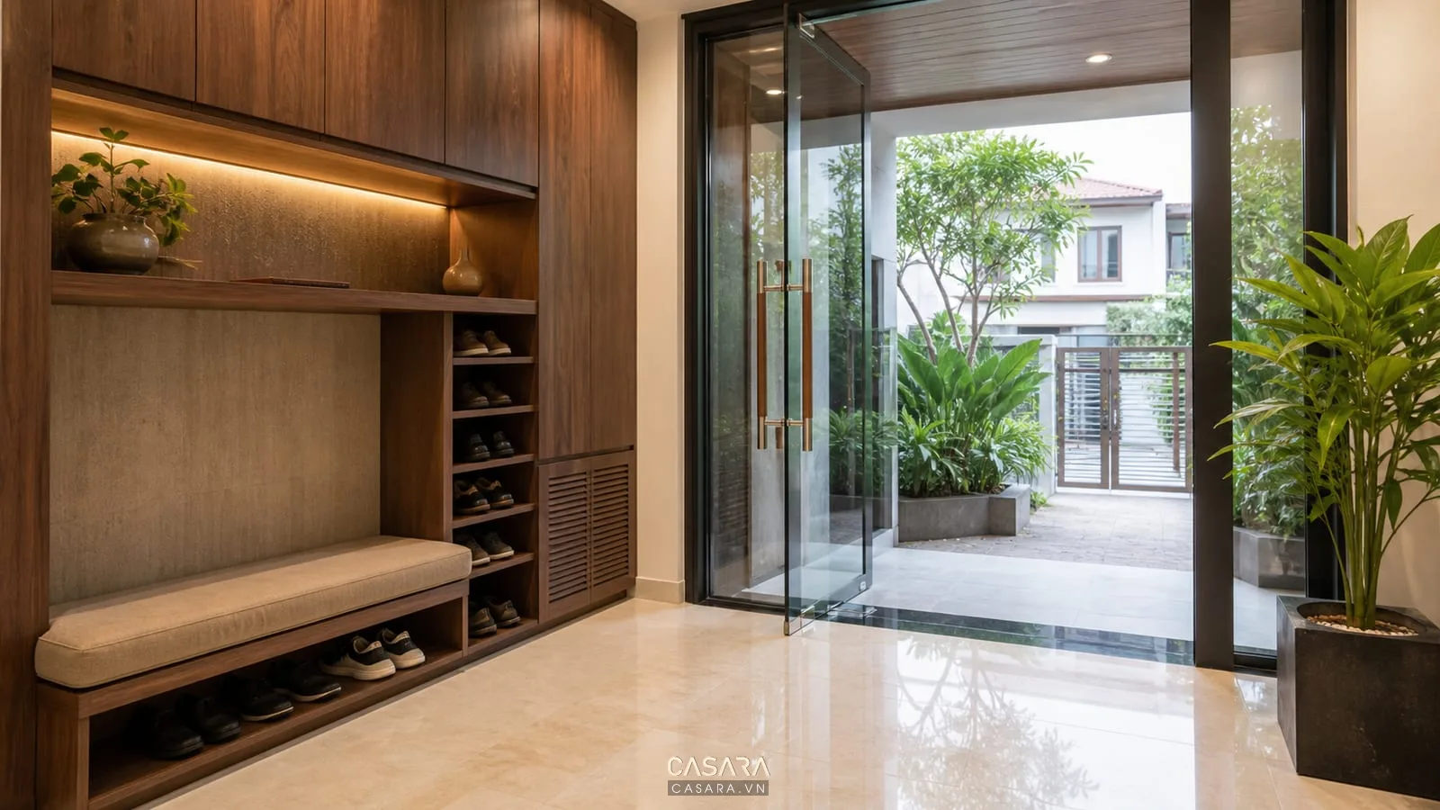 Thiết kế thi công nội ngoại thất khu sảnh vào với tủ giày ghế thay giày cửa kính hiên cây xanh và sàn đá
