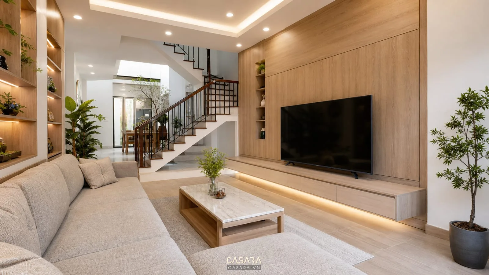 thiết kế nội thất nhà phố tp hcm phong cách hiện đại có phòng khách gỗ sáng sofa vách tivi cầu thang và cây xanh