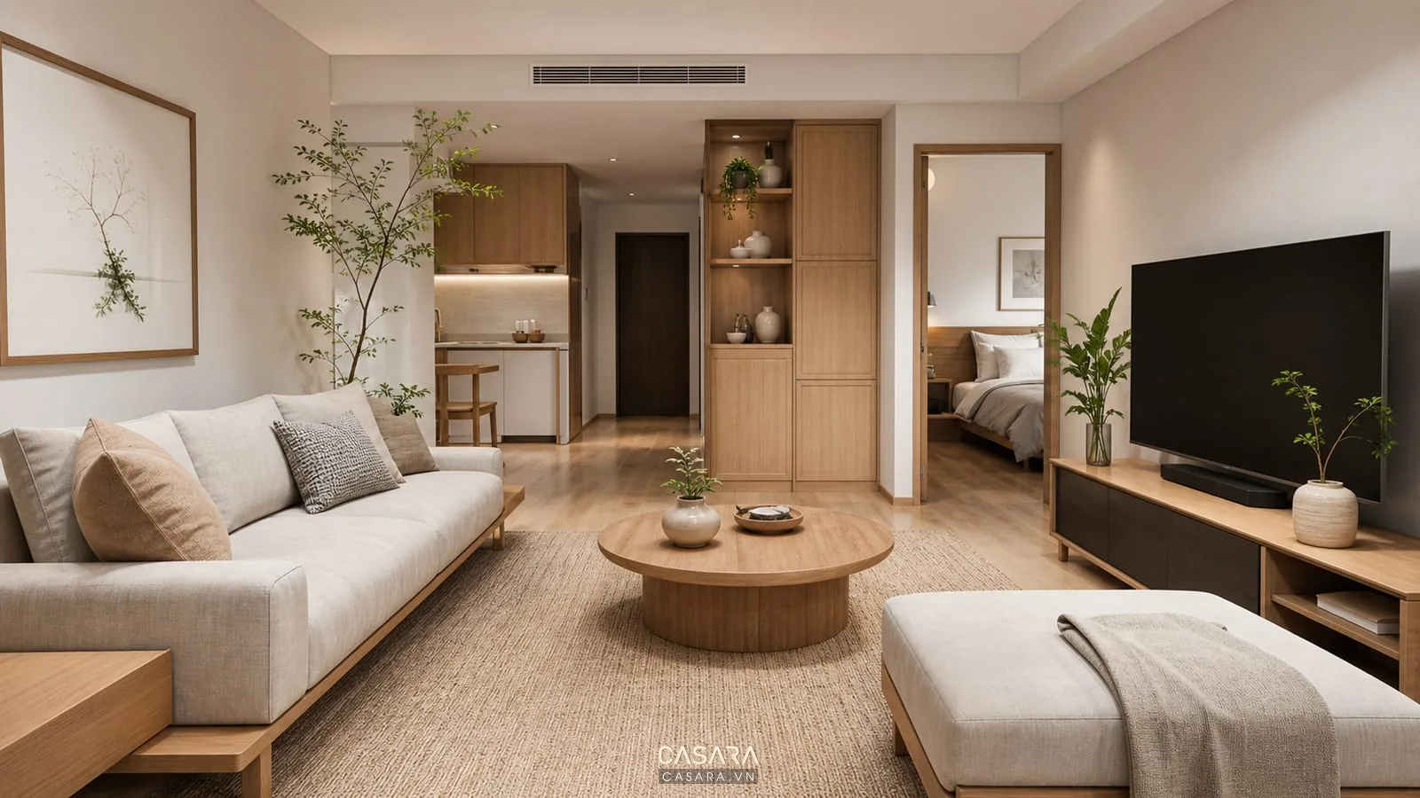 Trang trí chung cư 2 phòng ngủ phong cách Japandi có sofa thấp bàn trà tròn gỗ sáng cây xanh và tủ tivi tối giản