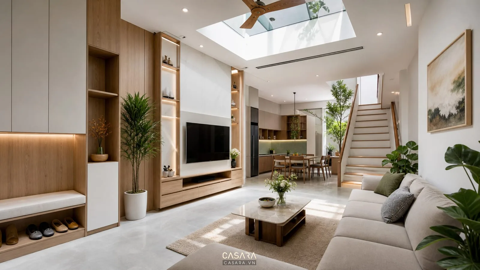 Nhà phố TP HCM trang trí nội thất trọn gói có phòng khách liên thông bếp cầu thang tủ giày kệ tivi và ánh sáng giếng trời